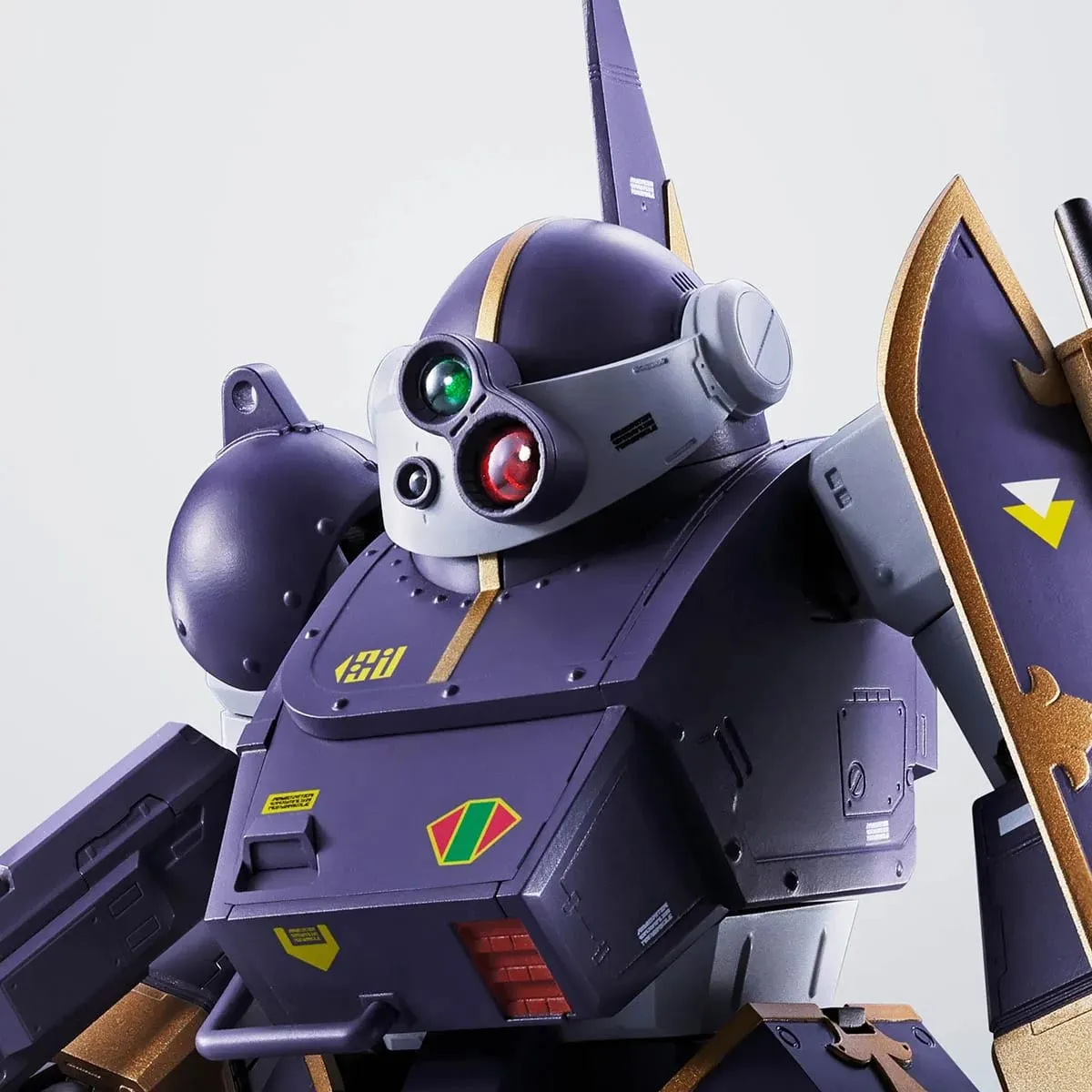 HI-METAL R Belzerga (WP) upper body in dark purple armor with gold trim, three-lens turret head, heraldic shield on the left arm and the tall Pile Bunker blade behind, official BANDAI SPIRITS product photo