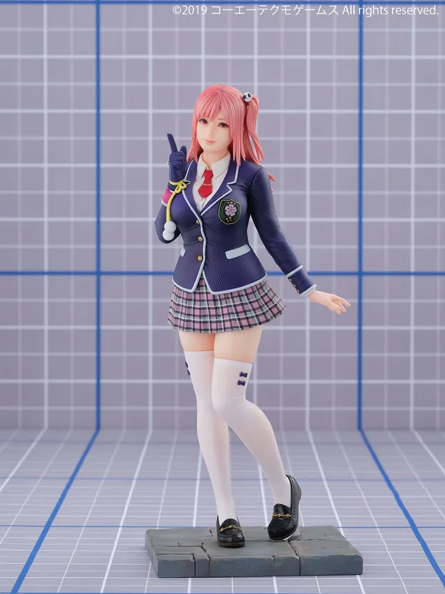 Kaiyodo 1/7 scale Honoka from Dead or Alive 6 in her school blazer and plaid skirt, one finger raised, standing on a stone-pavement base, official product photo