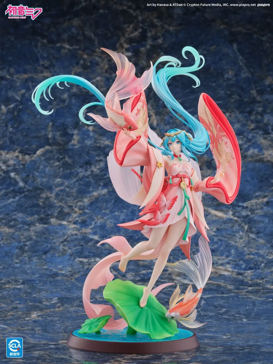 Kaiyodo 1/7 scale Hatsune Miku Goldfish Ver. in a red and pink Chinese-style robe, floating above a lotus-leaf base with translucent goldfish swimming around her, official product photo