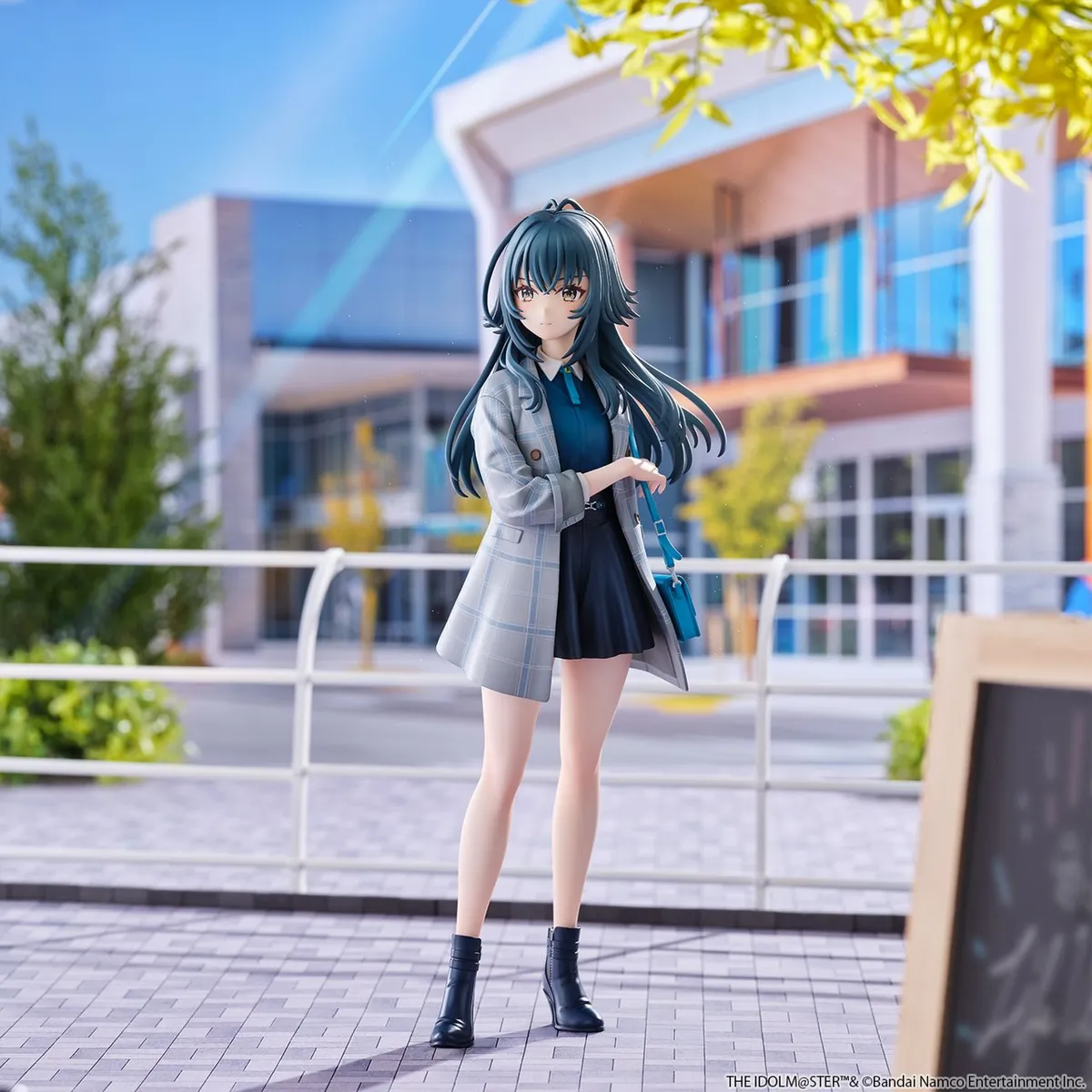 Union Creative 1/6 scale Temari Tsukimura figure from Gakuen iDOLM@STER, a dark-haired idol in a gray plaid coat over a navy shirt and dark culottes, teal shoulder bag, standing on a plaza in front of a glass building, official product photo